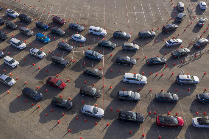 In an aerial view from a drone, cars line up at Dodger Stadium for COVID-19 testing in Los Angeles, California.