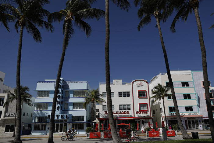 Visitors bike along South Beach in Miami Beach, Fla. Tourism has suffered during the coronavirus pandemic and the state is coming into high tourism season when it would typically see visitors from Canada and the northeast U.S.