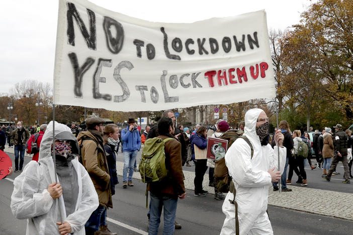 Demonstrators rally Wednesday against pandemic restrictions in front of the Brandenburg Gate in Berlin.
