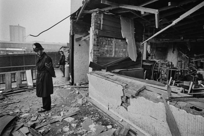 A police officer stands before damage caused by one of two pub bombings in 1974 in Birmingham, England.