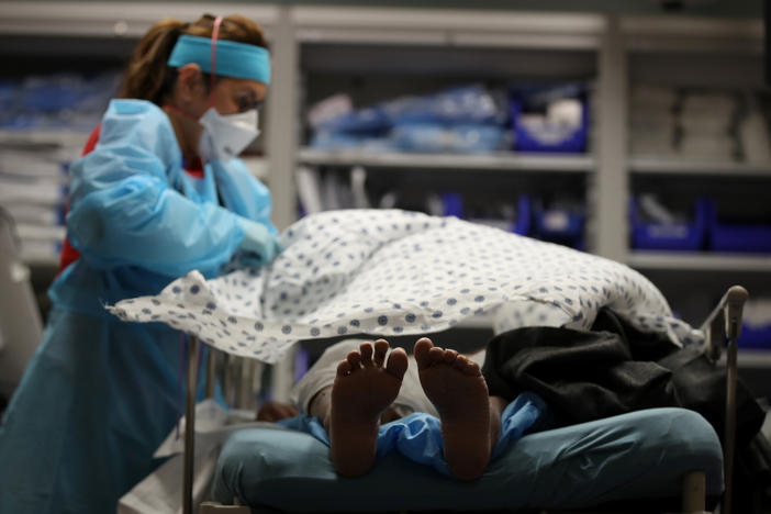 A nurse places a blanket over a patient that had just been admitted to the emergency room at Regional Medical Center in San Jose, California.