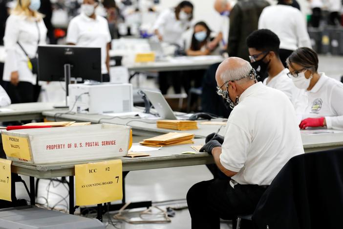 Election workers count absentee ballots earlier this month in Detroit, the county seat of Wayne County, Mich.
