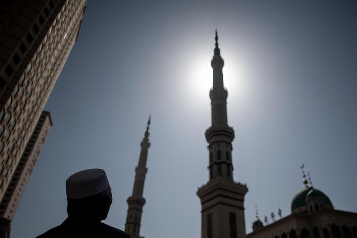 An ethnic Hui Muslim man stands in front of Laohuasi Mosque in Linxia, Gansu province, in 2018. Chinese Muslims are most densely clustered in the northwestern regions of Gansu, Ningxia and Xinjiang, but live across the country, as they have for more than a millennium.