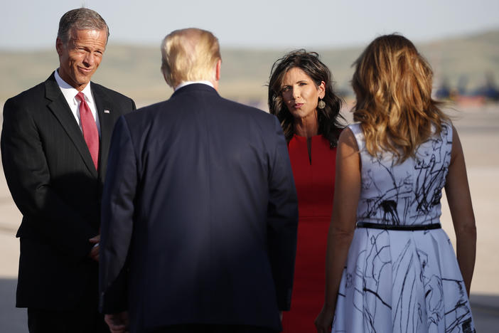 Sen. John Thune, R-S.D., and Gov. Kristi Noem greet President Trump and first lady Melania Trump upon arrival in Rapid City, S.D, in July. Trump was en route to Mount Rushmore National Memorial.