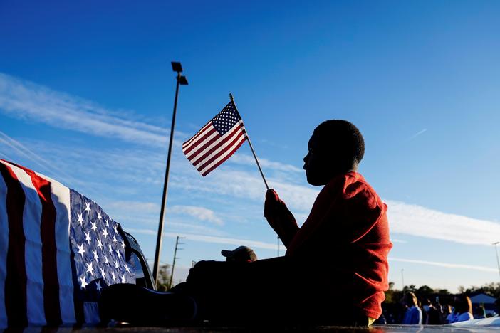 Xavier Watts, 9, waves an American flag during a campaign rally for Georgia Democratic U.S. Senate candidates Jon Ossoff and Raphael Warnock on Nov. 15 in Marietta, Ga.