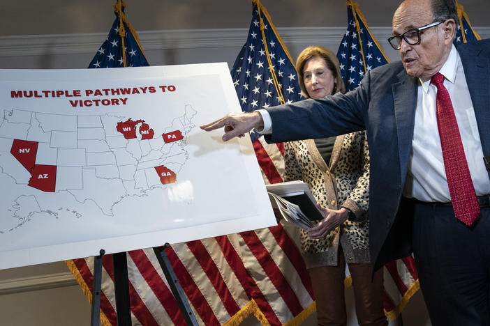 President Trump's lawyer Rudy Giuliani points to a map Thursday while speaking to the press about lawsuits related to the 2020 election at the Republican National Committee headquarters in Washington, D.C.