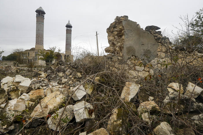 A mosque is seen through ruins in Aghdam on Thursday, just before the formal entry of Azerbaijani forces. As part of a recent peace agreement, Armenia ceded control of several regions in and around the disputed territory of Nagorno-Karabakh.