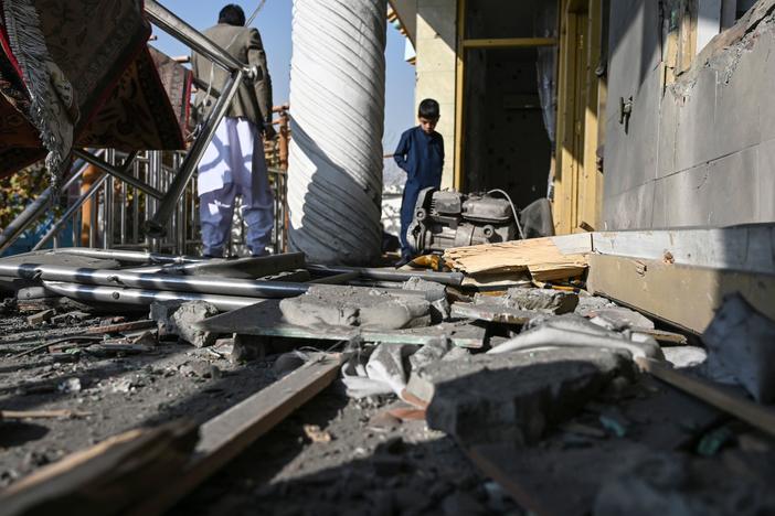 Residents inspect a damaged house after several rockets landed Saturday in Afghanistan's capital, Kabul. The Islamic State claimed responsibility for the attack, which comes the same day as U.S. Secretary of State Mike Pompeo's meeting with Taliban leaders in Qatar.