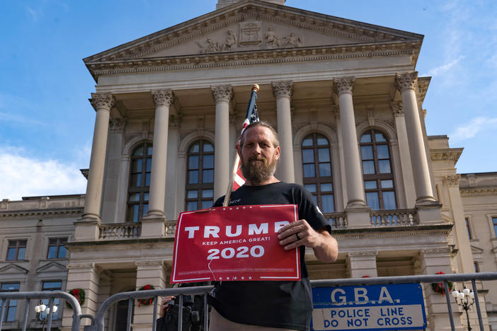 A supporter of President Trump protests outside the Georgia State Capitol on Saturday in Atlanta. The president's campaign has requested a vote recount in the state.