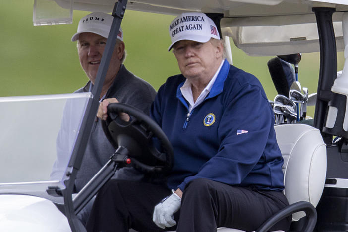 President Trump drives a golf cart Sunday at Trump National Golf Club in Sterling, Va.