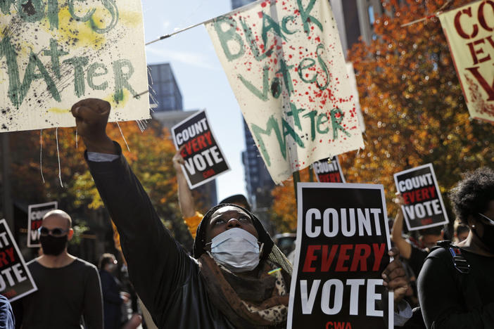 Zhanon Morales, 30, of Philadelphia raises a fist during a Nov. 5 voting rights rally. President Trump's campaign unsuccessfully used spurious claims of voter fraud to invalidate votes in Philadelphia and other largely Black cities.