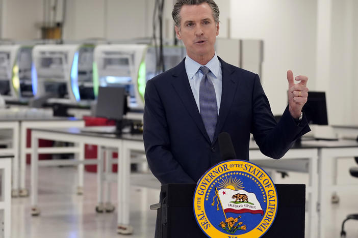 California Gov. Gavin Newsom speaks at a coronavirus testing facility last month in Valencia. Newsom says his family will quarantine for two weeks after three of his children came into close contact with someone who tested positive for the virus.