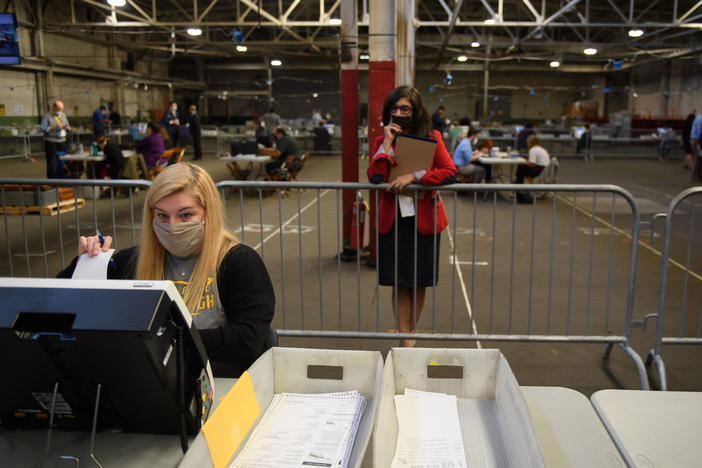 A poll watcher monitors the counting of ballots at the Allegheny County elections warehouse on Nov. 6 in Pittsburgh.