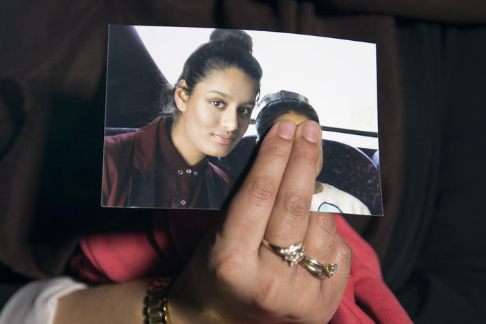 The eldest sister of Shamima Begum holds her sister's photo in 2015. Begum, who left London to join the Islamic State organization as a teenager, is now trying to return to the U.K. to argue that her British citizenship should not have been revoked.