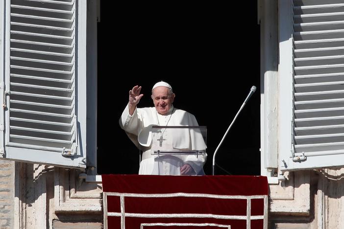 Pope Francis arrives at the window of his studio for the Angelus noon prayer in St. Peter's Square at the Vatican, Sunday.