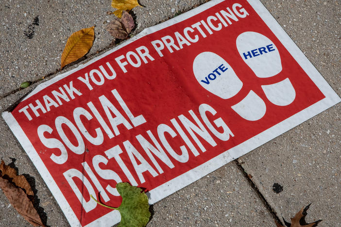 A social distancing sign on the ground. "Social distancing" was one of dozens of terms highlighted by researchers in Oxford Languages' 2020 Word of the Year campaign.
