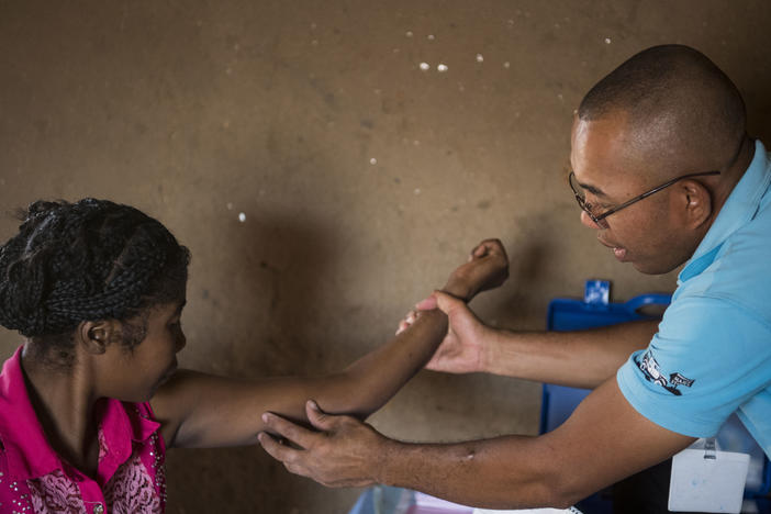 Nana (left) gets her birth control implant checked by Dr. Jean Rangomana during the Marie Stopes International mobile clinic in Besakoa, Madagascar, on April 9, 2018. Abortion is illegal under all circumstances in Madagascar, and Trump administration policies led to shortages of birth control there, health workers say.