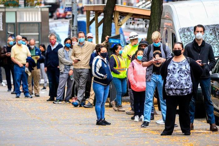 With new infections rising across the country, states are struggling to slow the spread, and testing can barely keep up. Here, people line up outside a coronavirus testing site this month in New York.