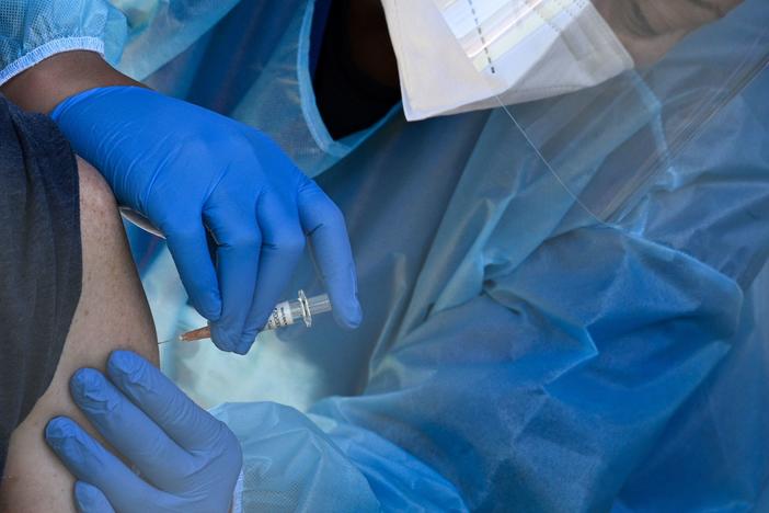 A flu vaccine is administered at a walk-up COVID-19 testing site, in San Fernando, Calif. Emergency use authorization is expected soon for vaccines for COVID-19.