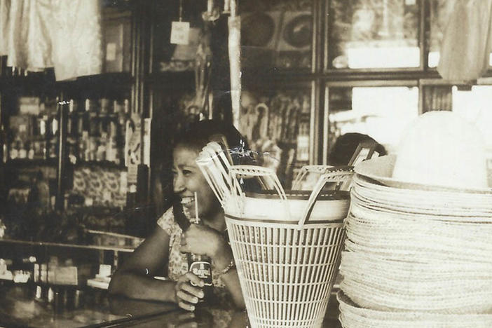 A young Crescenciana Tan working as cashier at a local grocery store in the Philippines in 1960.