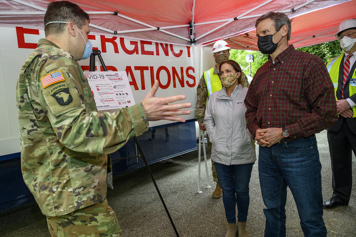 Tennessee Gov. Bill Lee (right) tours a temporary hospital site in April with his wife, Maria Lee. The overflow hospital, intended to help with the surge in COVID-19 hospitalizations, won't be able to take patients if there aren't additional doctors and nurses available to provide treatment.