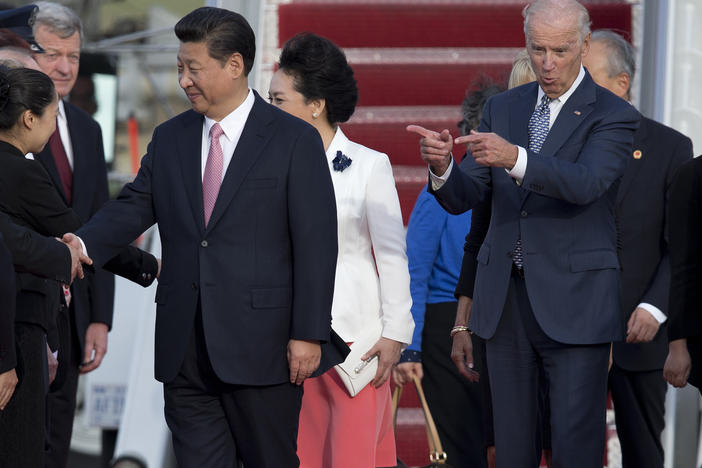 Then-Vice President Joe Biden gestures toward Chinese President Xi Jinping and his wife Peng Liyuan during an arrival ceremony in Andrews Air Force Base, Md., Sept. 24, 2015.