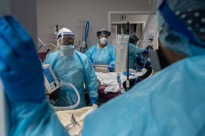 Medical staff prepare for an intubation procedure on a COVID-19 patient in a Houston intensive care unit. In some parts of the U.S., as hospitals get crowded, hospital leaders are worried they may need to implement crisis standards of care.