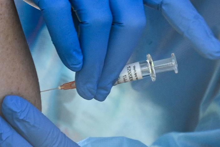 A flu vaccine is administered at a walk-up COVID-19 testing sit in San Fernando, Calif. A COVID-19 vaccine could soon win emergency use authorization from the FDA.