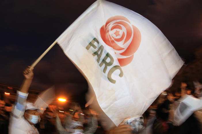 A former FARC guerrilla member waves a FARC political party flag during a demonstration in Bogota on Nov. 2. A federal court overturned an asylum decision Wednesday, holding that FARC death threats counted as persecution.×