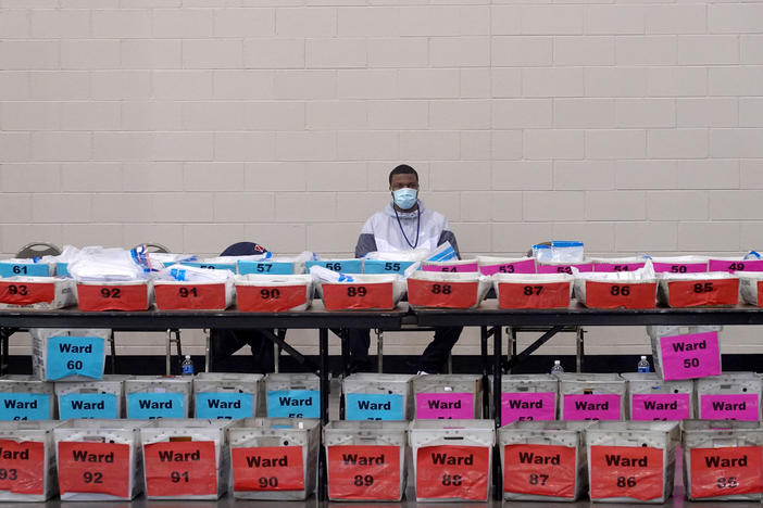 An election official pauses during the ballot recount earlier this month at the Wisconsin Center in Milwaukee. After recounts in Milwaukee and Dane counties, President-elect Joe Biden narrowly increased his winning margin over President Trump.