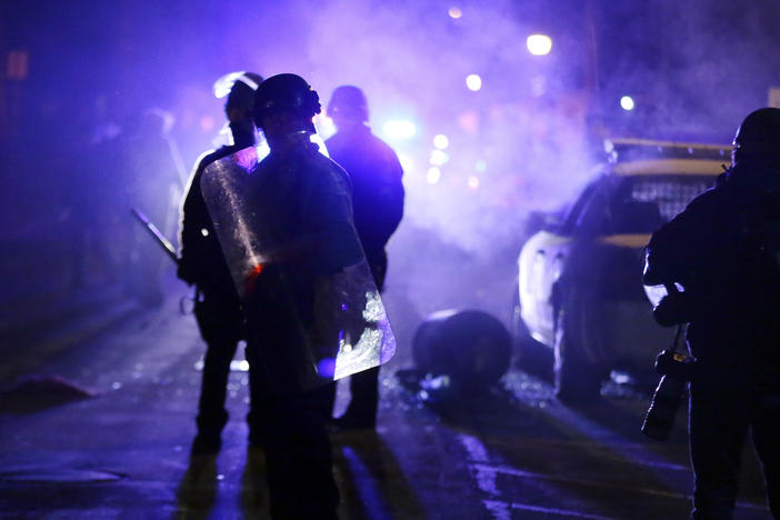 Police officers in Ferguson, Mo., during a protest in 2014. Advocates want the Justice Department to step up its oversight of law enforcement in the incoming administration.