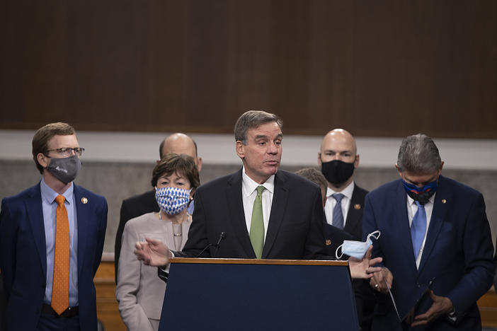 Sen. Mark Warner speaks alongside a bipartisan group of lawmakers as they announce a proposal for a $908 billion coronavirus relief bill on Tuesday.