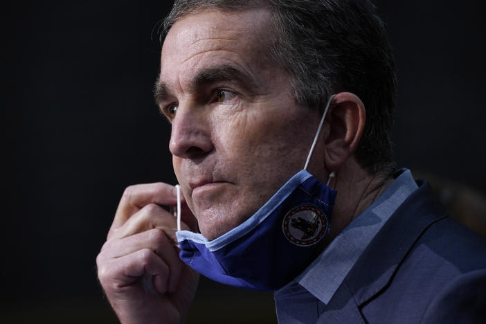 Virginia's Campbell County is pushing back on Gov. Ralph Northam's coronavirus restrictions, saying they violate individual rights. Here, Northam removes his mask during a COVID-19 briefing last month in Richmond.