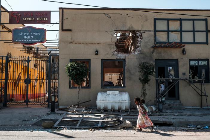 A child plays in front of a hotel damaged by mortar shelling last month in Humera, in the Tigray region of Ethiopia. On Wednesday, U.N. officials announced they had reached a deal with Ethiopian leaders to allow humanitarian groups access to the disputed region.