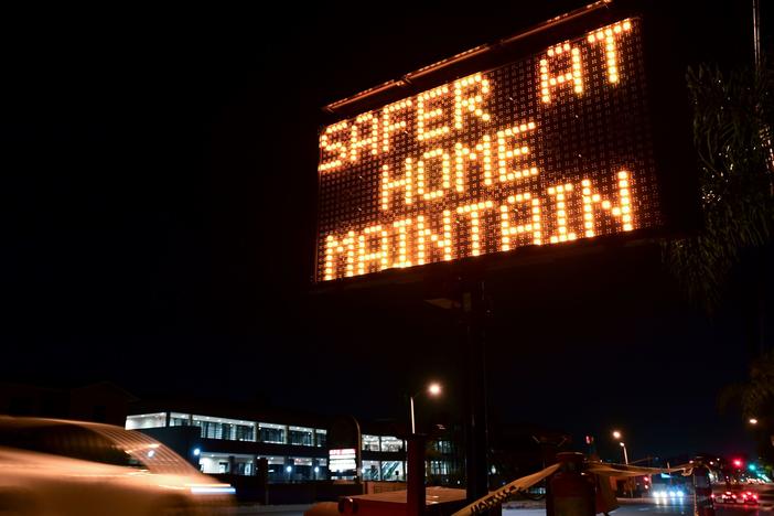 A sign reminds motorists of Los Angeles County's stay-at-home regulation. On Wednesday, the Centers for Disease Control and Prevention rolled out its revised guidelines for people potentially exposed to the coronavirus.