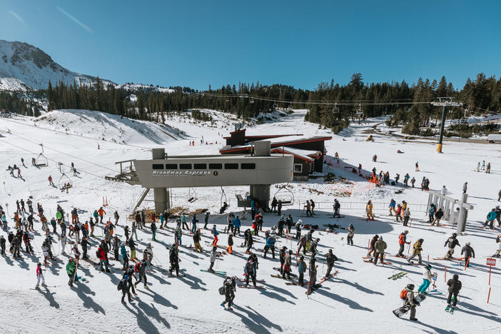 Skiers and snowboarders wait in a socially distanced lift line at Mammoth Mountain on Nov. 15.