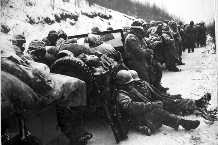 Marines of the 5th and 7th regiments who hurled back a surprise onslaught by three Chinese communist divisions wait to withdraw from the Chosin Reservoir area circa December 1950.