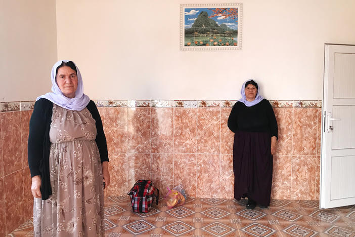 Nofa Khudeda (left) and a neighbor in the village of Tel Qasab on the day Khudeda and her husband returned after six years in a camp for displaced Yazidis. Khudeda and her husband, Ali Edo, repaired and renovated the house, which had been looted by ISIS fighters and then militias that fought ISIS.