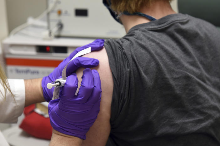 This photo provided by the University of Maryland School of Medicine shows the first patient enrolled in Pfizer's COVID-19 coronavirus vaccine clinical trial receiving an injection in May.