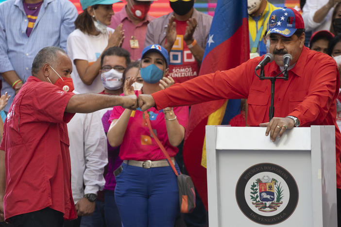 Diosdado Cabello (left), a candidate in Venezuela's upcoming National Assembly elections, bumps fists with Venezuelan President Nicolás Maduro during a closing campaign rally in Caracas, Venezuela, on Thursday. Venezuelans will vote for a new National Assembly on Sunday.