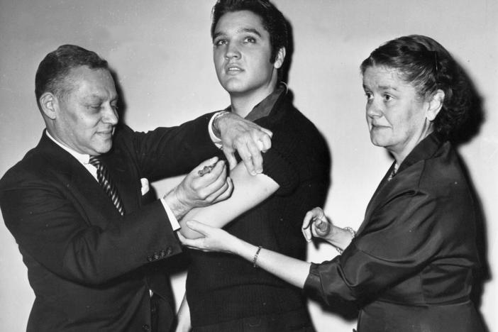 Elvis Presley receives a polio vaccine in New York City in 1956 in an effort to inspire public confidence in the vaccine. The Ad Council says it will be recruiting trusted influencers for its campaign around the coronavirus vaccine.