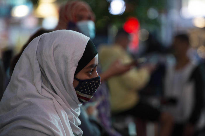 A woman wears a hijab and an American flag mask during an election celebration last month in New York's Times Square.