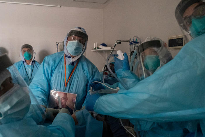 Health care workers in Houston, Texas, perform a procedure on a patient in the COVID-19 intensive care unit on Thanksgiving. This past week has seen continued steep growth in cases, hospitalizations and deaths from COVID-19.