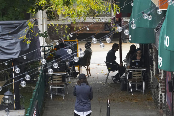 Customers sit outside a restaurant offering outdoor service in New York in October. A new survey shows that tipped service workers are facing a marked increase in harassment during the coronavirus pandemic.