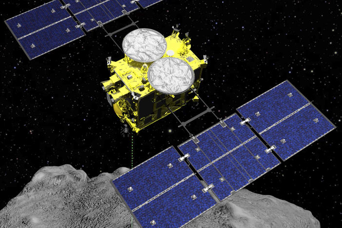 This computer-generated image shows the Hayabusa2 spacecraft above the asteroid Ryugu. This weekend, the sample collected by the spacecraft arrived on Earth after a six-year mission.