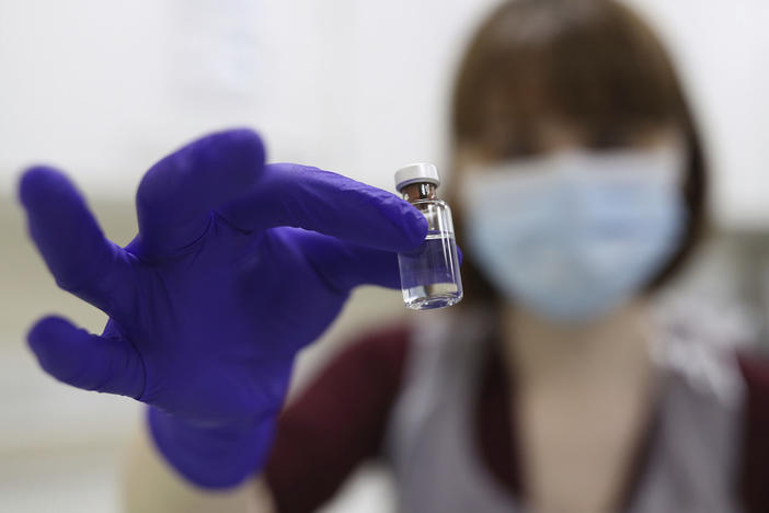 A National Health Service pharmacy technician at the Royal Free Hospital in London simulates the preparation of the Pfizer vaccine Friday for support staff training ahead of this week's rollout.