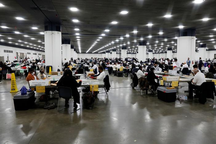 Detroit election workers count absentee ballots for the 2020 general election at TCF Center on Nov. 4. Election offices around the U.S. say they couldn't have carried out this year's challenging election without help from a nonprofit tied to Facebook CEO Mark Zuckerberg.