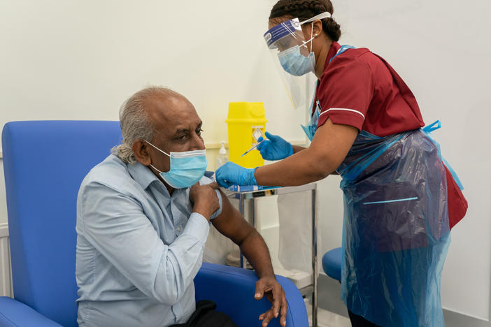 A nurse prepares to administer a COVID-19 vaccine at Croydon University Hospital in London.