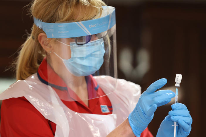 A nurse prepares to inject residential care home staff with the Pfizer/BioNTech COVID-19 vaccine in Belfast, Northern Ireland.