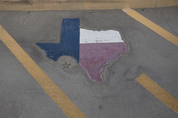 A map of Texas is displayed on a parking spot at the Old Glory Memorial in El Paso, Texas, last year.